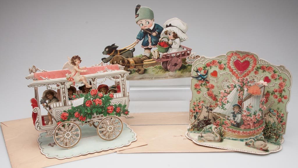 GERMAN STAND-UP VALENTINES, LOT OF THREE: GERMAN STAND-UP VALENTINES, LOT OF THREE, including a carriage with five passengers. First quarter 20th century. 7 1/2" and 8" H. Provenance: From the collection of the late Betty Jane Renn, Sunbury, 