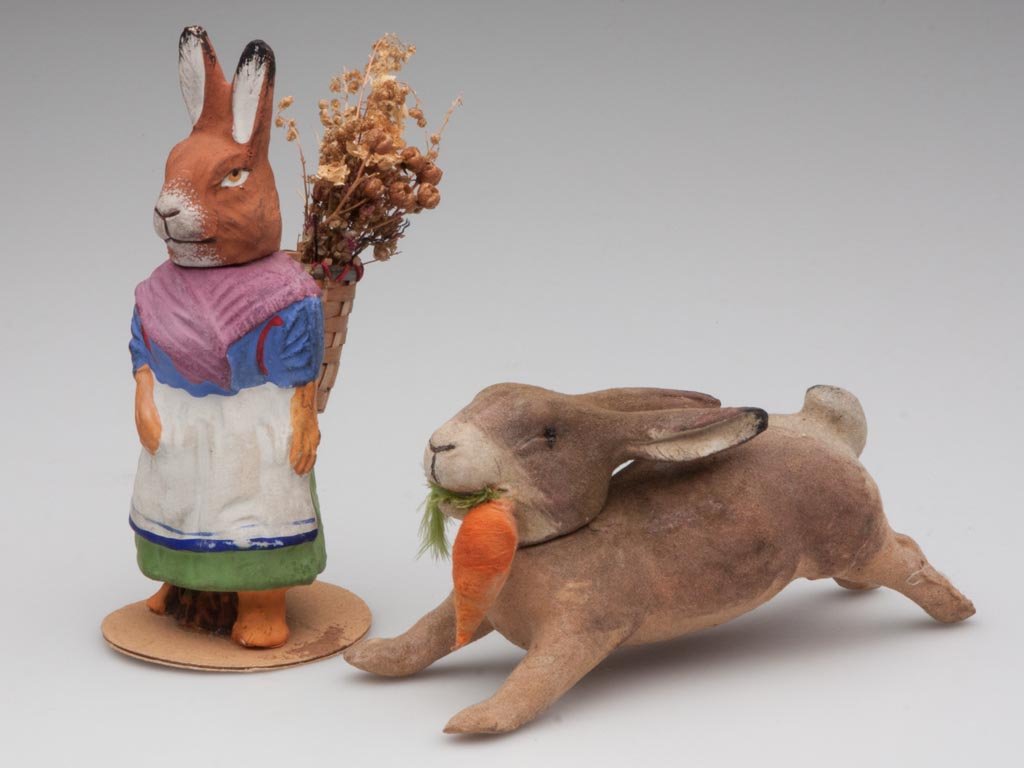 GERMAN PAPIER-MACHE RABBIT CANDY CONTAINERS, LOT OF TWO: GERMAN PAPIER-MACHE RABBIT CANDY CONTAINERS, LOT OF TWO, one standing with basket on back, the other running with carrot in mouth, each head is removable, not marked. First quarter 20th century. 5 1/2