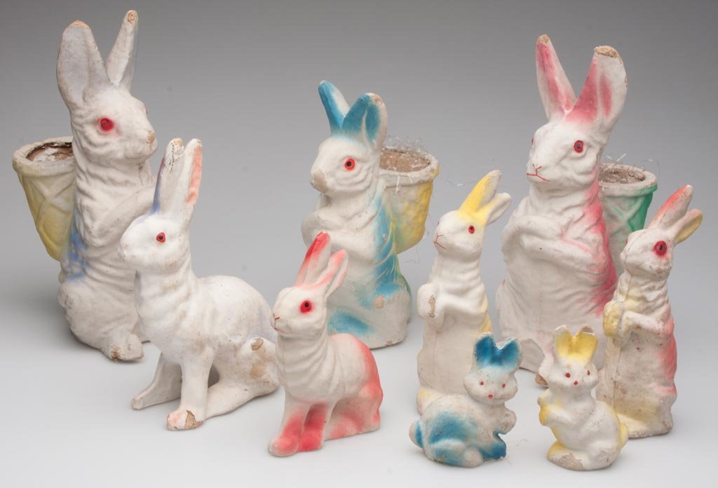 PAPIER-MACHE EASTER RABBITS, LOT OF NINE: PAPIER-MACHE EASTER RABBITS, LOT OF NINE, three with baskets on back for candy, each with air-brushed decoration. First half 20th century. 3 3/4" to 11" H. Provenance: From the collection of the late 