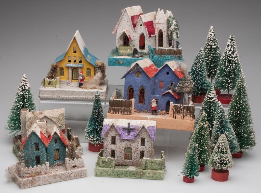 JAPANESE CHRISTMAS VILLAGE HOUSES AND TREES, LOT OF 17: JAPANESE CHRISTMAS VILLAGE HOUSES AND TREES, LOT OF 17, comprising six structures, two with a bisque Santa Claus figure, and 11 trees. Mid 20th century. 3" to 7" H. Provenance: From the collection of 