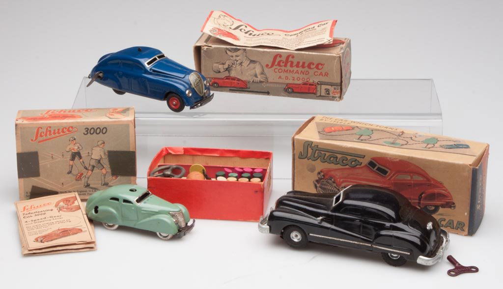 GERMAN WIND-UP TIN AUTOMOBILES, LOT OF THREE: GERMAN WIND-UP TIN AUTOMOBILES, LOT OF THREE, comprising Schuco Command Car A. D. 2000, Schuco Telesteering Car 3000, and Straco 100 "Hit and Go" Car, each with original box and accessories, two with