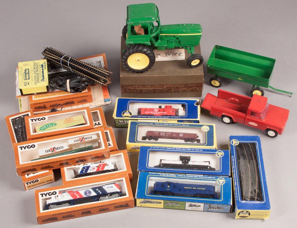 ASSORTED TRAIN AND FARM TOYS: ASSORTED TRAIN AND FARM TOYS, including AHM and Tyco trains with accessories, John Deere tractor and wagon, and a Tonka truck. Second half 20th century. Various sizes. Provenance: Property of a Virgin