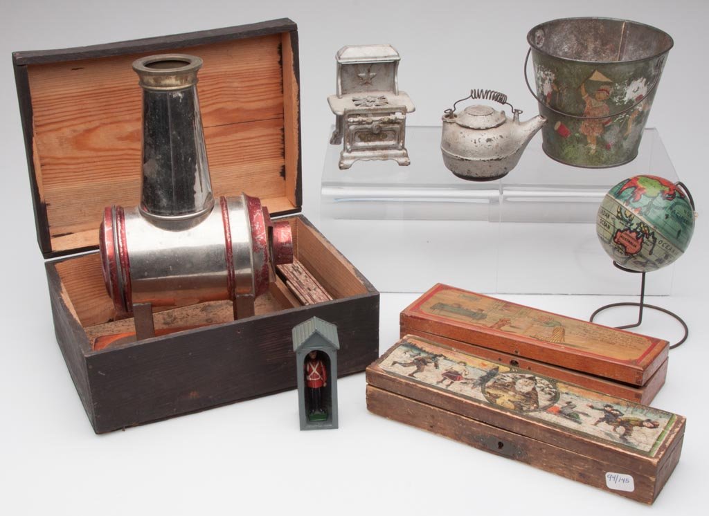 ASSORTED TOYS, LOT OF EIGHT: ASSORTED TOYS, LOT OF EIGHT, including a magic lantern in original box, two pencil boxes, lithographed tin and cast iron. Fourth quarter 19th to mid 20th century. Lantern 9 1/2" H. Provenance: From th