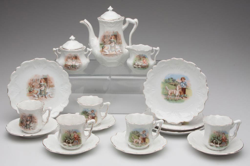 GERMAN CHINA CHILD'S TEA SET, 17 PIECES: GERMAN CHINA CHILD'S TEA SET, 17 PIECES, transfer decorated with vignettes of children and animals, not marked. First quarter 20th century. Plates 6" D. Provenance: The collection of the late Richard