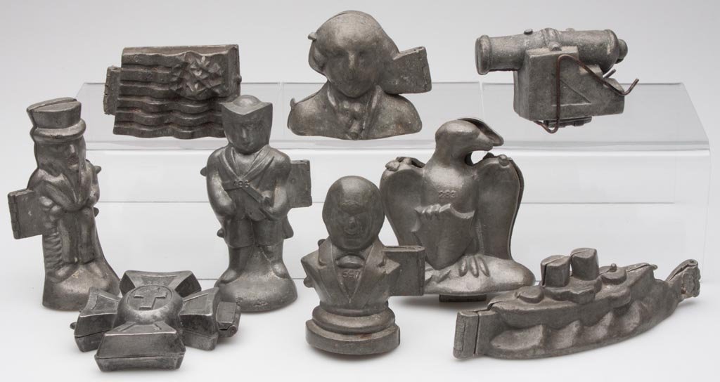 ASSORTED PATRIOTIC FIGURAL ICE CREAM / CHOCOLATE MOLDS,: ASSORTED PATRIOTIC FIGURAL ICE CREAM / CHOCOLATE MOLDS, LOT OF NINE, hinged lead or pewter, including Uncle Sam, American flag, George Washington, eagle with shield, battleship, etc. First half 20th c
