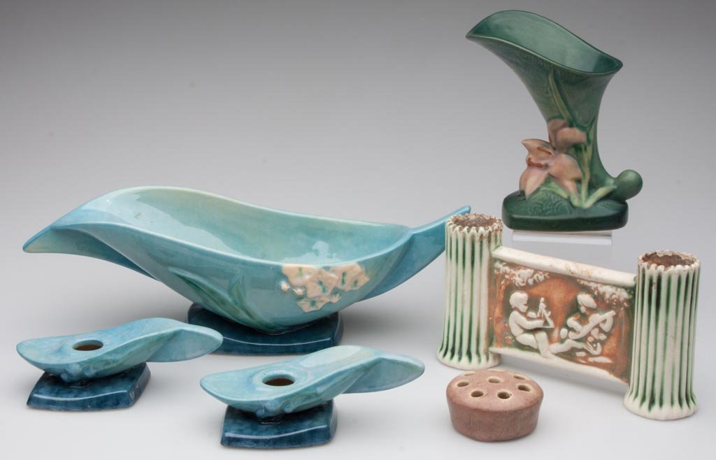 ROSEVILLE ART POTTERY ARTICLES, LOT OF SIX: ROSEVILLE ART POTTERY ARTICLES, LOT OF SIX, including a Wincraft three-piece console set. First half 20th century. 1 1/4" to 6" H. Provenance: From the collection of the late Betty Jane Renn, Sunbury,