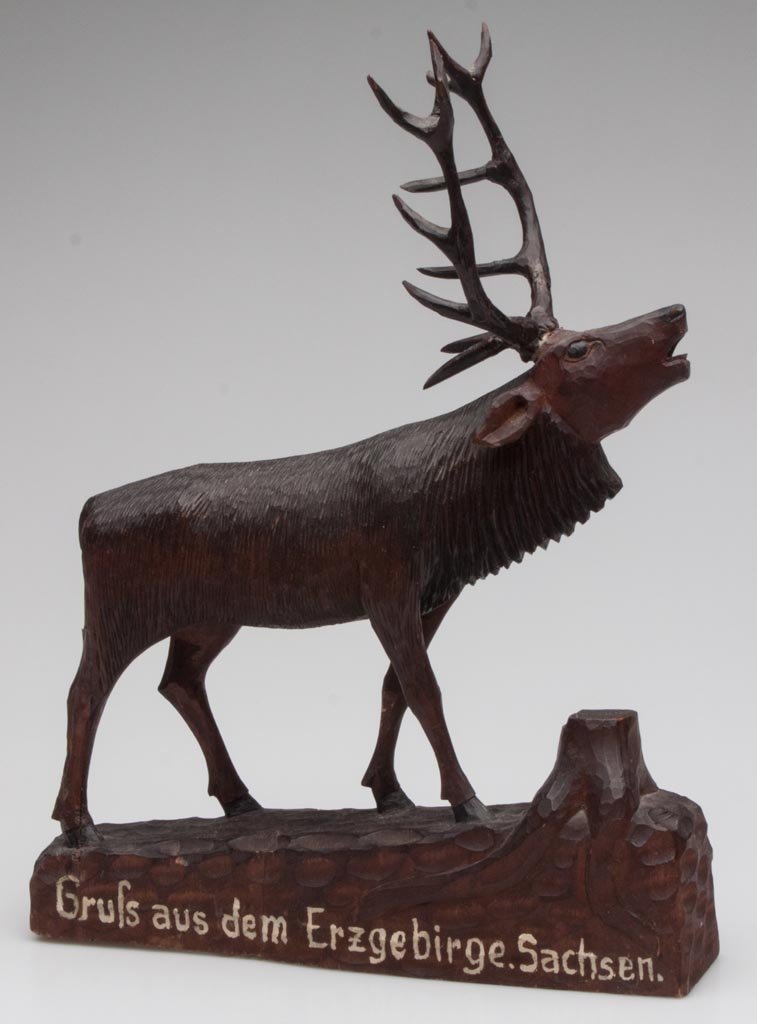 BLACK FOREST CARVED STAG FIGURE: BLACK FOREST CARVED STAG FIGURE, white painted inscription on both sides of base, signed under base. Late 19th/early 20th century. 13" H, 9 1/2" L.