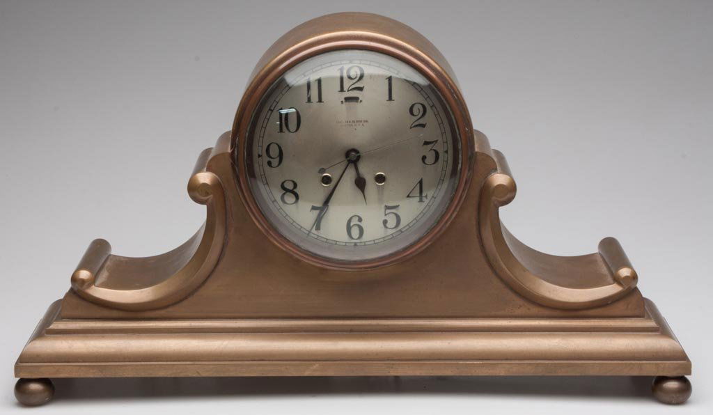 VINTAGE CHELSEA TAMBOUR NO. 5 MODEL CLOCK CASE: VINTAGE CHELSEA TAMBOUR NO. 5 MODEL CLOCK CASE, heavy brass, silvered dial lettered "Chelsea Clock Co./Boston, U.S.A.". Now fitted with an electric movement. Circa 1922. 11 1/2" H, 20 1/2" L.