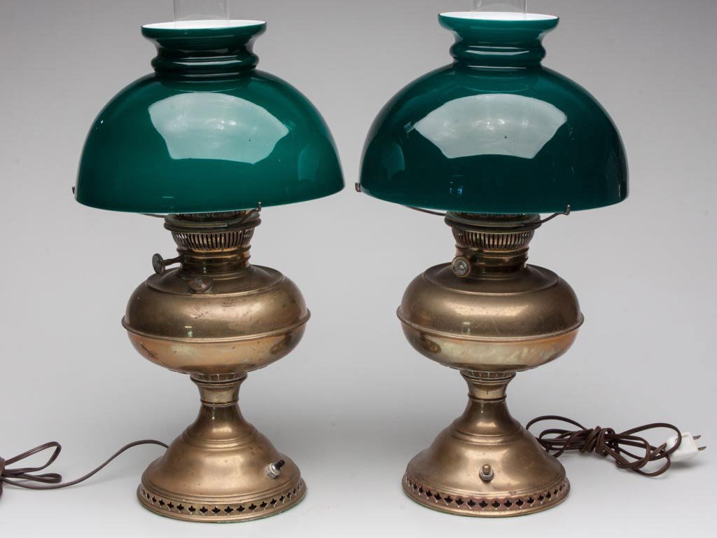 RAYO BRASS KEROSENE LAMPS, LOT OF TWO: RAYO BRASS KEROSENE LAMPS, LOT OF TWO, each electrified and with cased green shade. 20th century. 21" HOA.