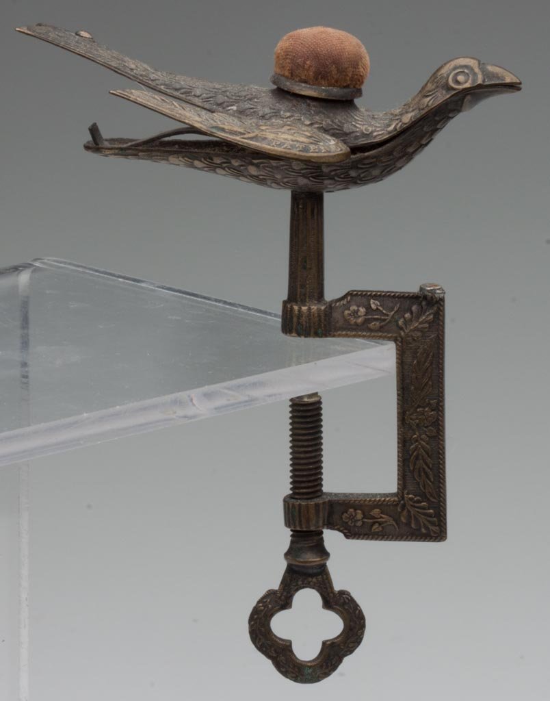WATERMAN'S SEWING BIRD CLAMP: WATERMAN'S SEWING BIRD CLAMP, cast and stamped brass, wings stamped "PATENTED" and "FEB. 15, 1853", with top pin cushion. Second half 19th century. 5" H. Provenance: From the collection of the late Be