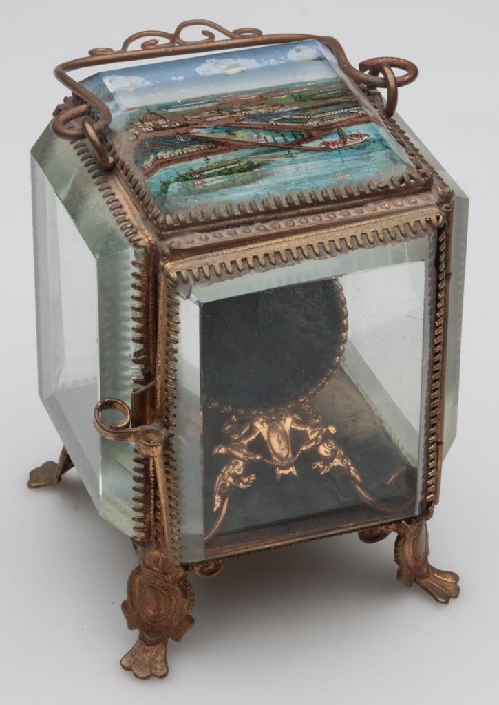 CHICAGO COLUMBIAN EXPOSITION POCKET WATCH BOX: CHICAGO COLUMBIAN EXPOSITION POCKET WATCH BOX, plate glass and stamped brass, reverse painted scene on top inscribed "CHICAGO 1893", interior with original fabric and watch holder. Late 19th century. 