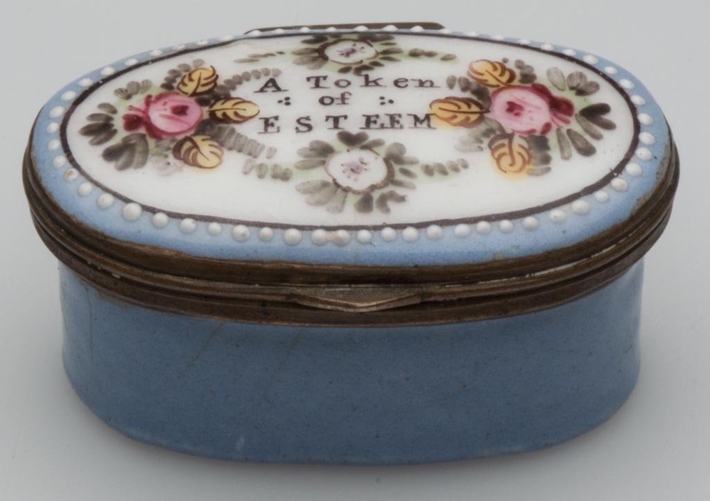 BATTERSEA ENAMEL PILL BOX: BATTERSEA ENAMEL PILL BOX, oval form with original mirror to lid interior, inscribed "A Token of Esteem" on top of lid. First half 19th century. 7/8" H, 1" x 1 3/4". Provenance: From the collection of