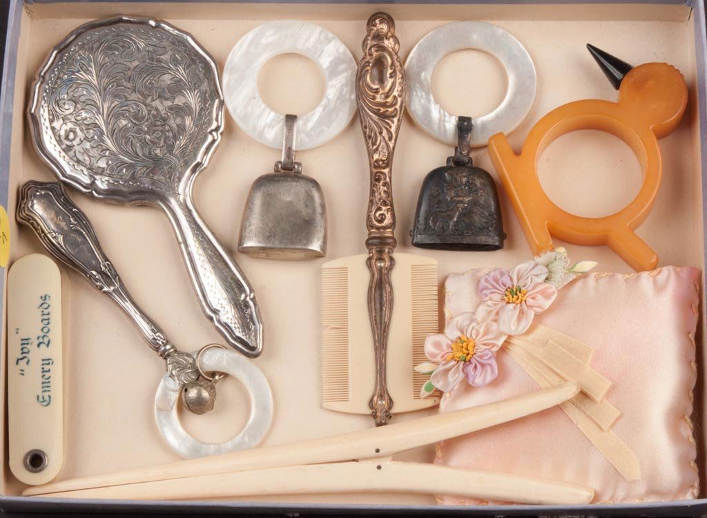 ASSORTED SILVER AND OTHER ACCOUTREMENTS, LOT OF NINE: ASSORTED SILVER AND OTHER ACCOUTREMENTS, LOT OF NINE, including three sterling and mother-of-pearl baby rattles/teething rings and an .800 silver child's hand mirror. Late 19th/first quarter 20th cent