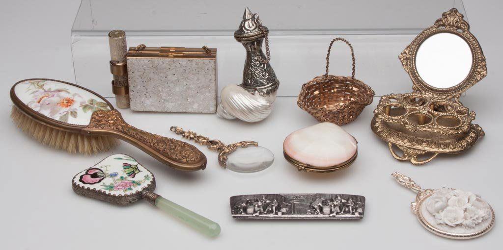 ASSORTED LADY'S ACCOUTREMENTS, LOT OF TEN: ASSORTED LADY'S ACCOUTREMENTS, LOT OF TEN, including a porcelain inset hair brush, two small hand mirrors, a comb marked Made in Denmark, and a compact. 20th century. Brush 8 1/2" L. Provenance: Prope