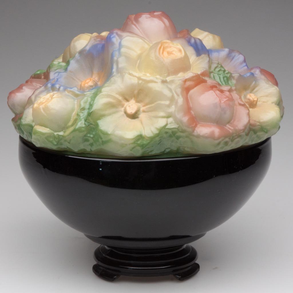 TIFFIN FLOWER CONSOLE GLASS NOVELTY LAMP: TIFFIN FLOWER CONSOLE GLASS NOVELTY LAMP, shiny puffy floral shade with polychrome decoration, fitted onto an opaque black base. United States Glass Co., Pittsburgh, PA. Circa 1925. 9" HOA, 8" D base.