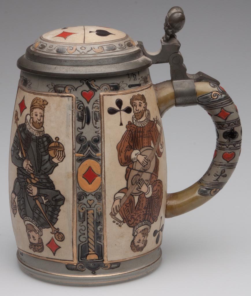 METTLACH 2093 SUITE OF CARDS STEIN: METTLACH 2093 SUITE OF CARDS STEIN, 1/2 liter, etched design, original lid with double-acorn thumb tab, fully marked under base. Fourth quarter 19th/first quarter 20th century. 6 1/4" HOA. Provenance: