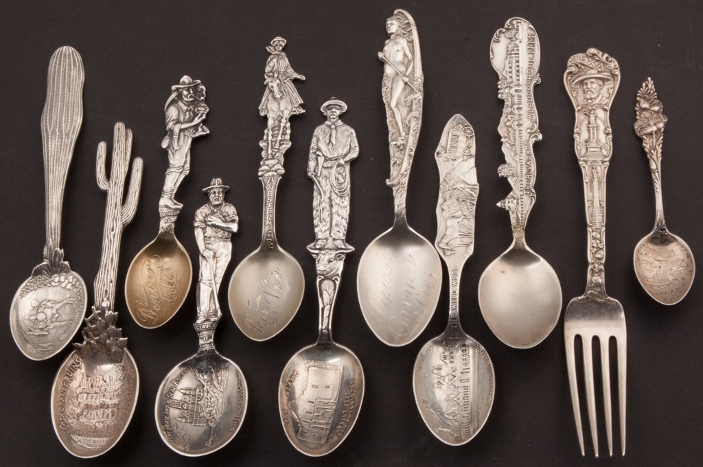 AMERICAN STERLING SILVER WESTERN THEME SOUVENIR SPOONS : AMERICAN STERLING SILVER WESTERN THEME SOUVENIR SPOONS / FORK, LOT OF 11, ornate figural handles including miners, cowboys, cowgirl, nude, etc. Weight: 8.11 ozt. Late 19th/early 20th century. 3 3/4" t