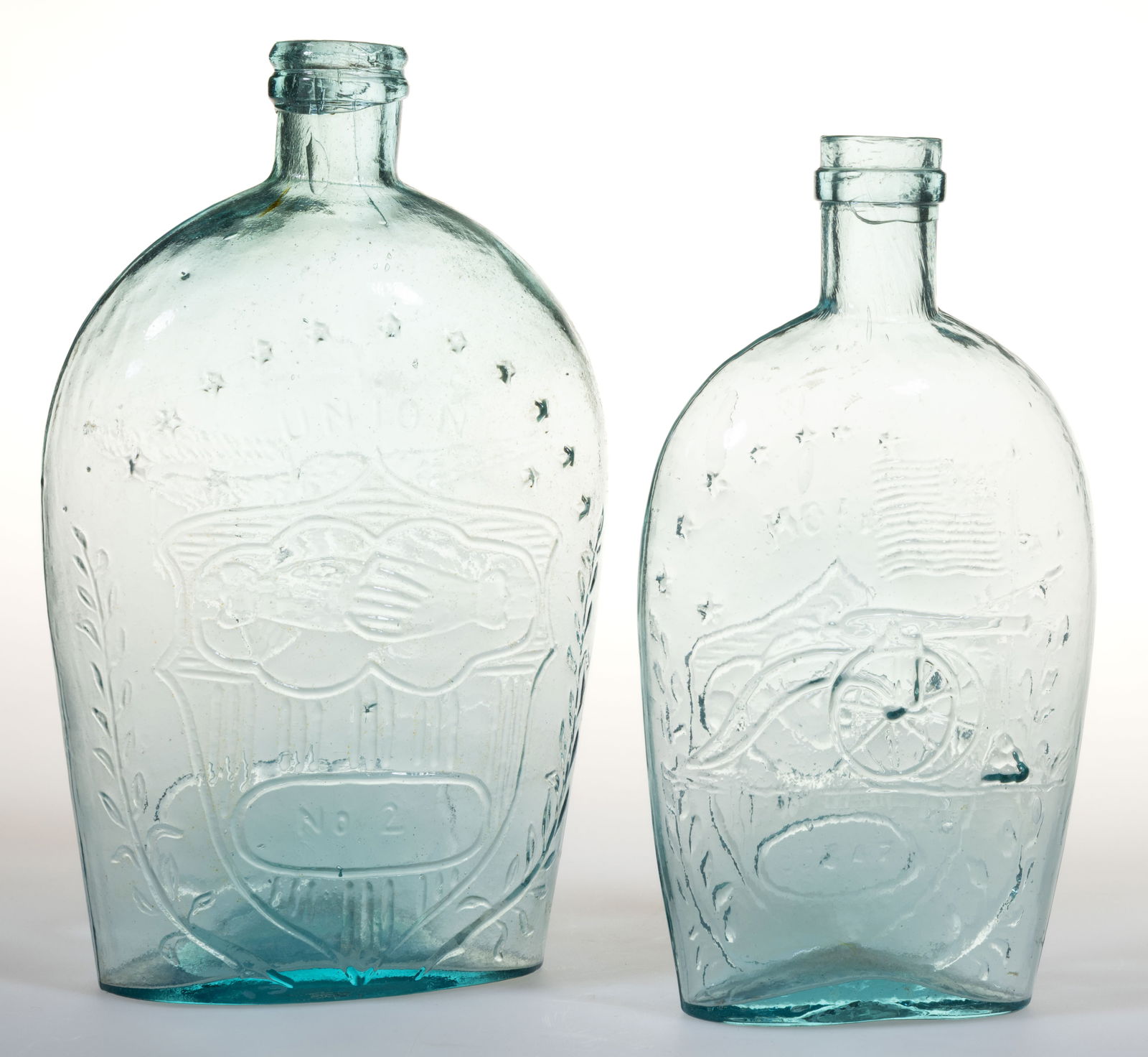 ASSORTED UNION CLASPED HANDS PICTORIAL / HISTORICAL FLASKS, LOT OF TWO: ASSORTED UNION CLASPED HANDS PICTORIAL / HISTORICAL FLASKS, LOT OF TWO, aquamarine, comprising a pint-sized GXII-40 with obverse having clasped hands in a shield above an oval frame with &qu