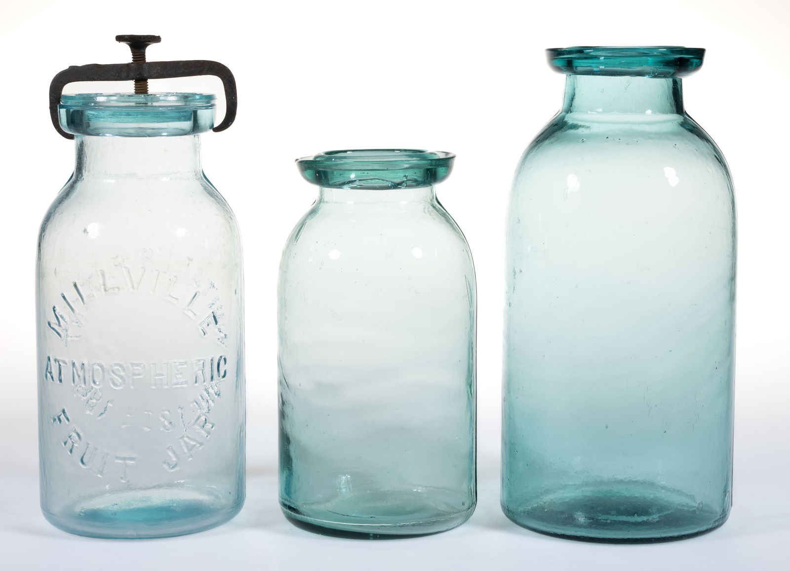 ASSORTED GLASS FRUIT JARS, LOT OF THREE: ASSORTED GLASS FRUIT JARS, LOT OF THREE, blue and greenish aquamarine, comprising a quart Millville Atmospheric Fruit Jar / Whitall's Patent 1861 retaining matching glass lid and metal screw band,