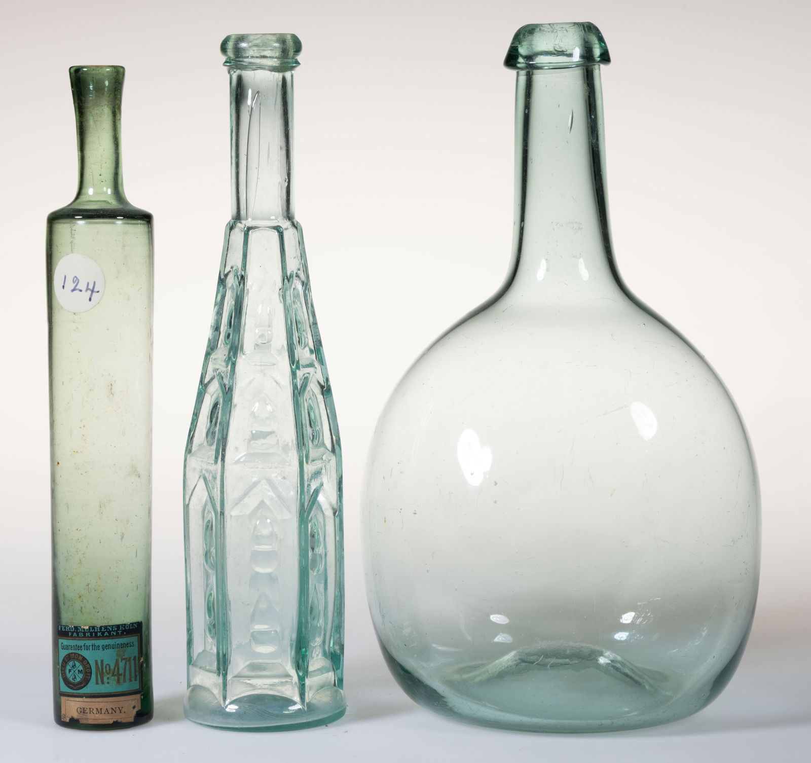 ASSORTED COMMERCIAL / UTILITY BOTTLES, LOT OF THREE: ASSORTED COMMERCIAL / UTILITY BOTTLES, LOT OF THREE, comprising a light blue-green chestnut flask with applied sloping collar and kick-up base with rough pontil mark, an aquamarine Cathedral peppersau