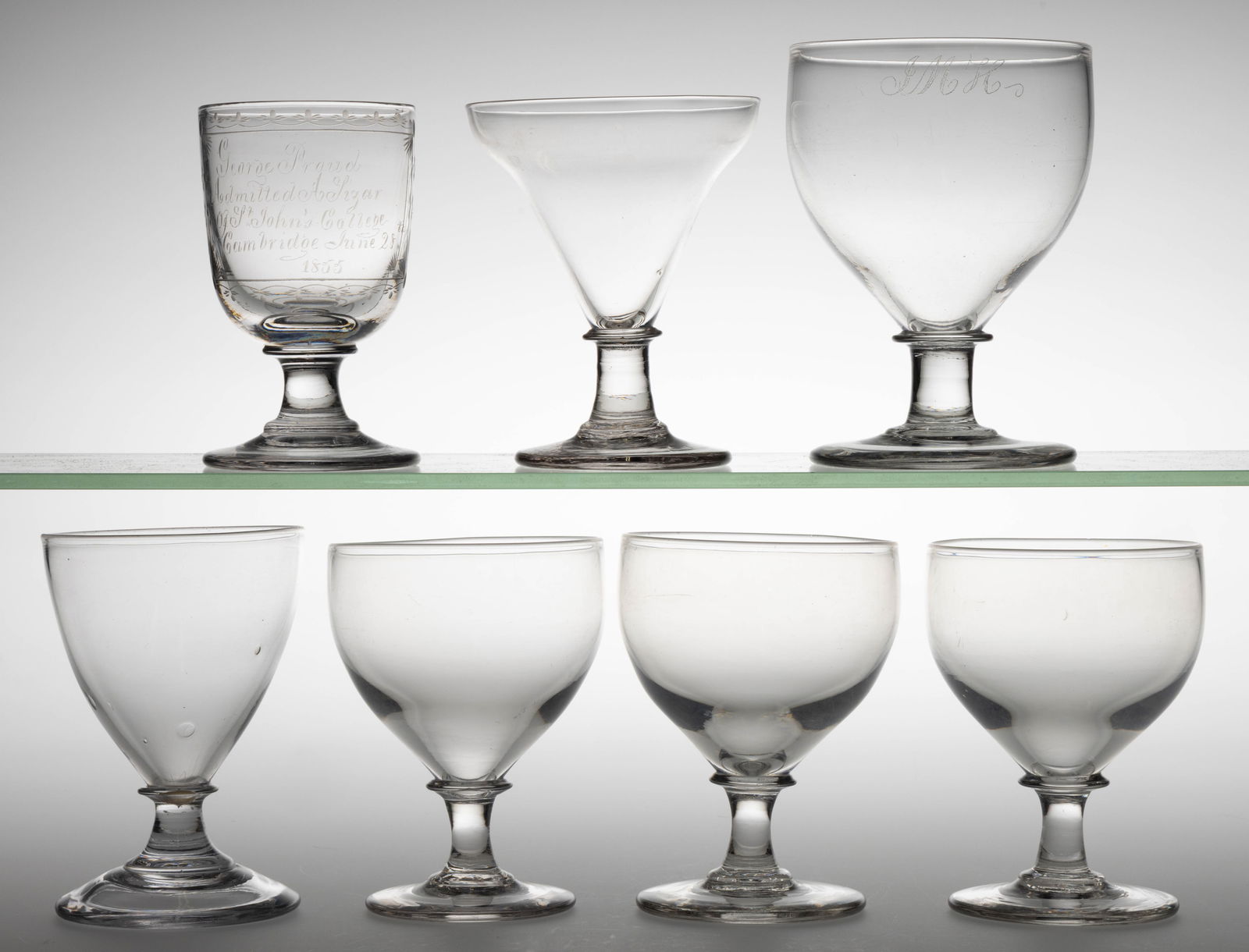 ENGLISH FREE-BLOWN GLASS RUMMERS / GOBLETS, LOT OF SEVEN: ENGLISH FREE-BLOWN GLASS RUMMERS / GOBLETS, LOT OF SEVEN, colorless lead glass, including a matching set of three ogee-bowl examples and a very similar but larger example with diamond-point engraved &