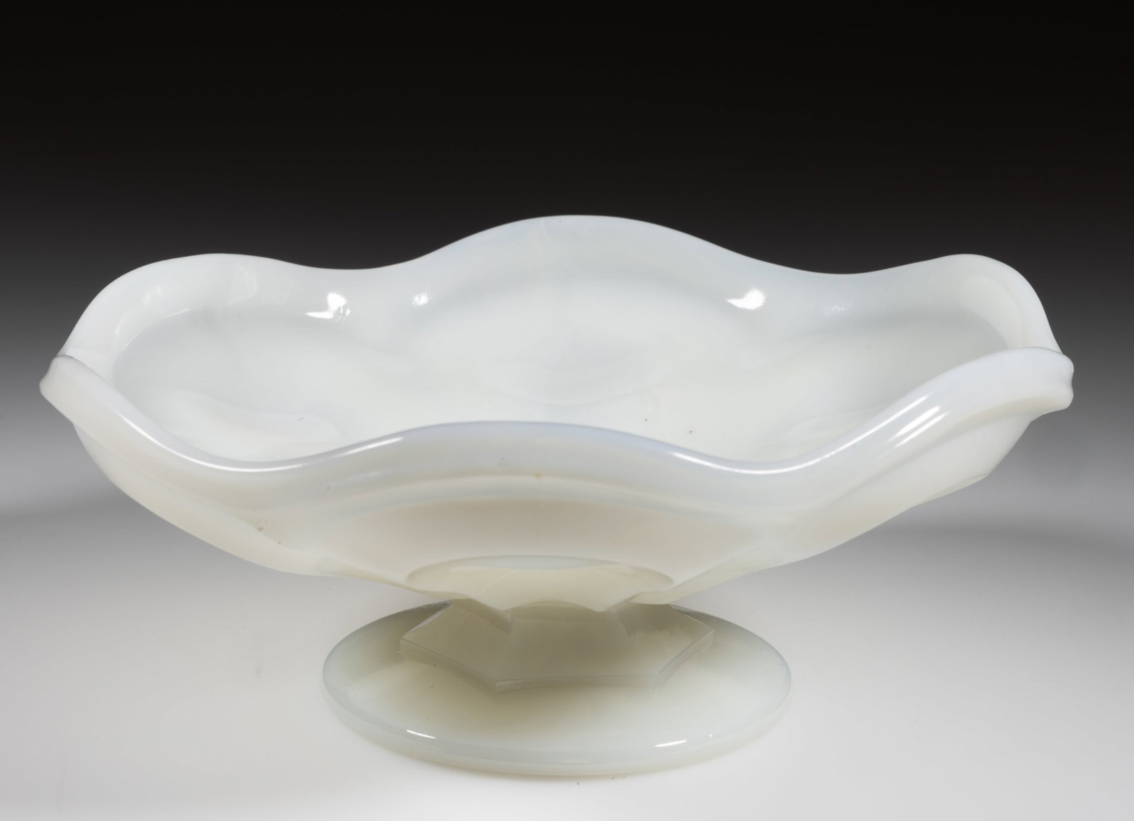 PRESSED O'HARA / LOOP LOW FOOTED BOWL: PRESSED O'HARA / LOOP LOW FOOTED BOWL, swirling milky slightly translucent white with hints of opalescence, shallow form with six loops and conforming rim scallops, raised on a short hexagonal ste