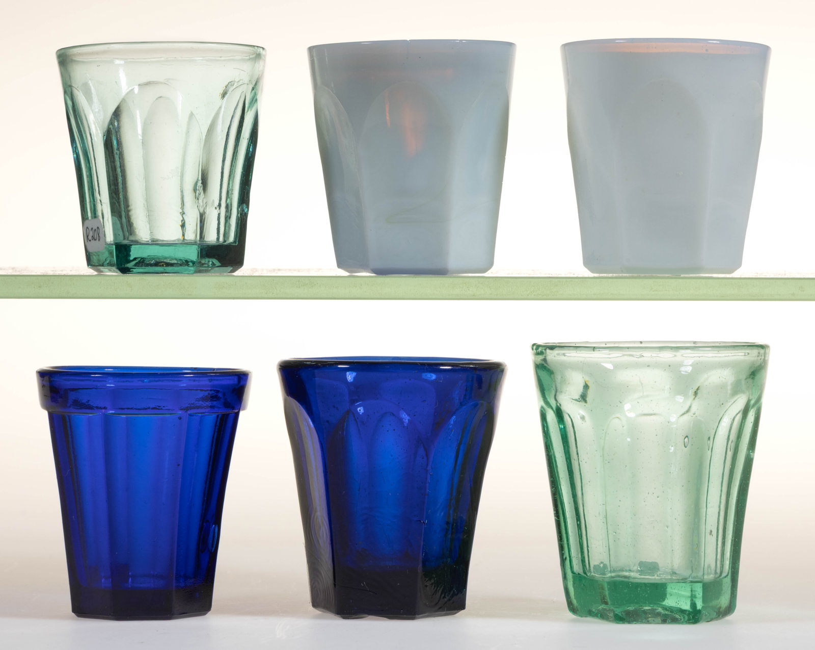 ASSORTED PRESSED GLASS TOY TUMBLERS / TASTERS, LOT OF SIX: ASSORTED PRESSED GLASS TOY TUMBLERS / TASTERS, LOT OF SIX, various colors, comprising two fiery opalescent six-flutes, a deep blue six-flute, a deep blue eight-panel, a pale green six-f