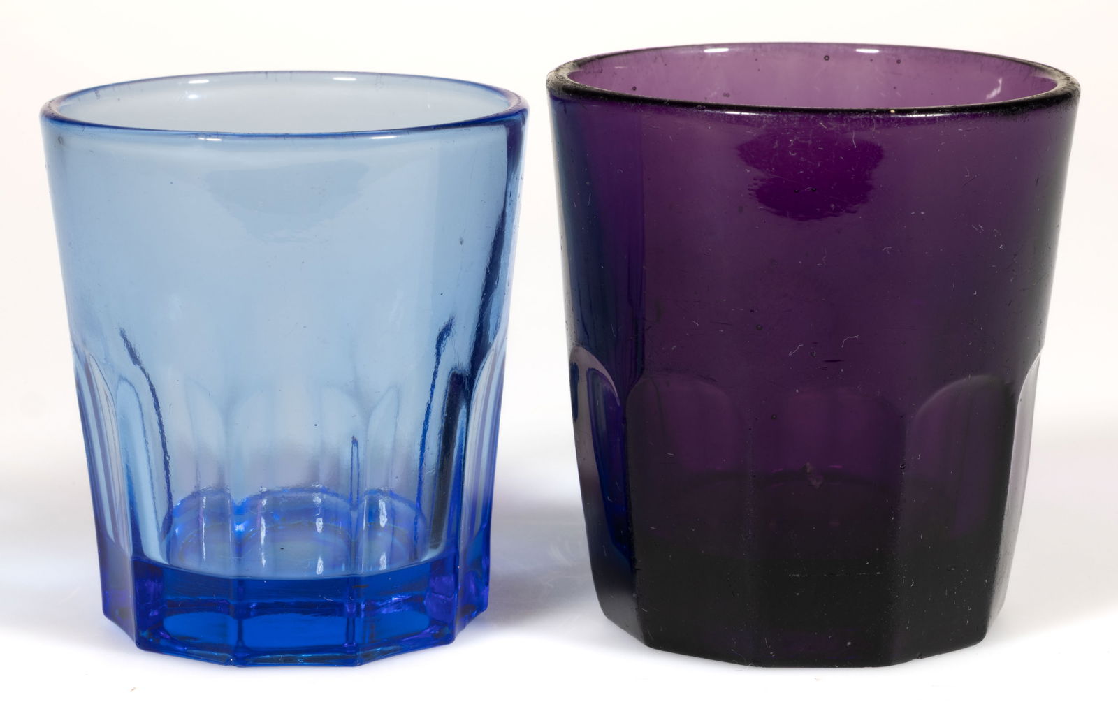 PRESSED TEN-FLUTE TUMBLERS, LOT OF TWO: PRESSED TEN-FLUTE TUMBLERS, LOT OF TWO, brilliant violet and transparent pale blue. Third quarter 19th century. 2 3/4" H, 2 1/2" D rim, and 2 1/2" H, 2 3/8" D rim. Provenance: