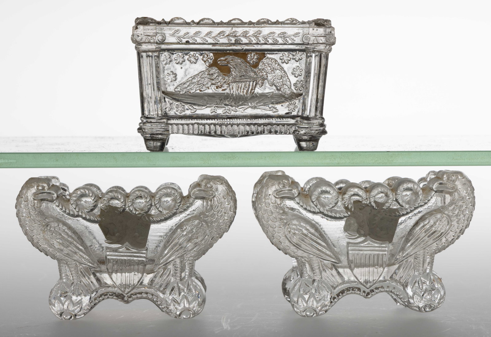 ASSORTED EE EAGLE AND SHIELD PRESSED GLASS OPEN SALTS, LOT OF THREE: ASSORTED EE EAGLE AND SHIELD PRESSED GLASS OPEN SALTS, LOT OF THREE, colorless, comprising of an EE-1A, an EE-3, and an EE-3B. Plentiful and remaining two scarce. Boston & Sandwich Glass Co. 