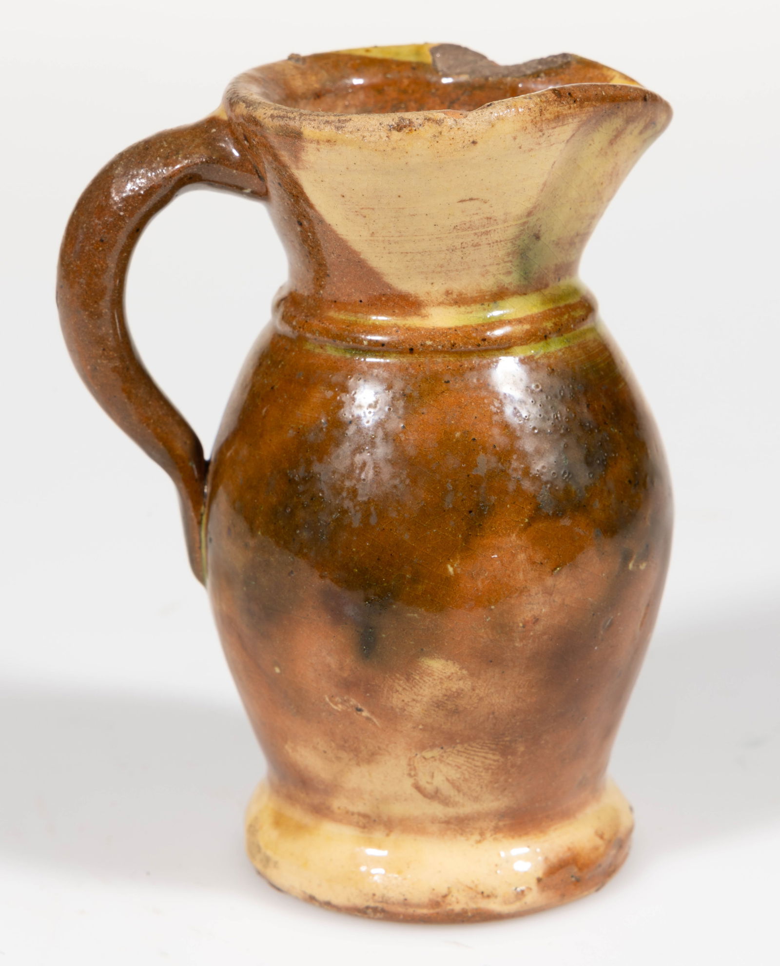 STRASBURG, VIRGINIA, SHENANDOAH VALLEY OF VIRGINIA POLYCHROME-DECORATED DIMINUTIVE PITCHER: STRASBURG, VIRGINIA, SHENANDOAH VALLEY OF VIRGINIA POLYCHROME-DECORATED EARTHENWARE / REDWARE DIMINUTIVE PITCHER, lead-, manganese-, and light copper-glazed over a slip wash, elongated ovoid form