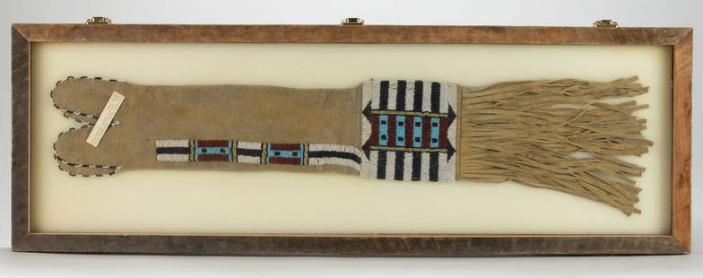 NATIVE AMERICAN PLAINS INDIAN BEADED HIDE PIPE / TOBACCO BAG: NATIVE AMERICAN PLAINS INDIAN BEADED HIDE PIPE / TOBACCO BAG, sinew sewn, brain tanned according to label, having "four-tab" top with beaded edges, each side with lane stitched designs