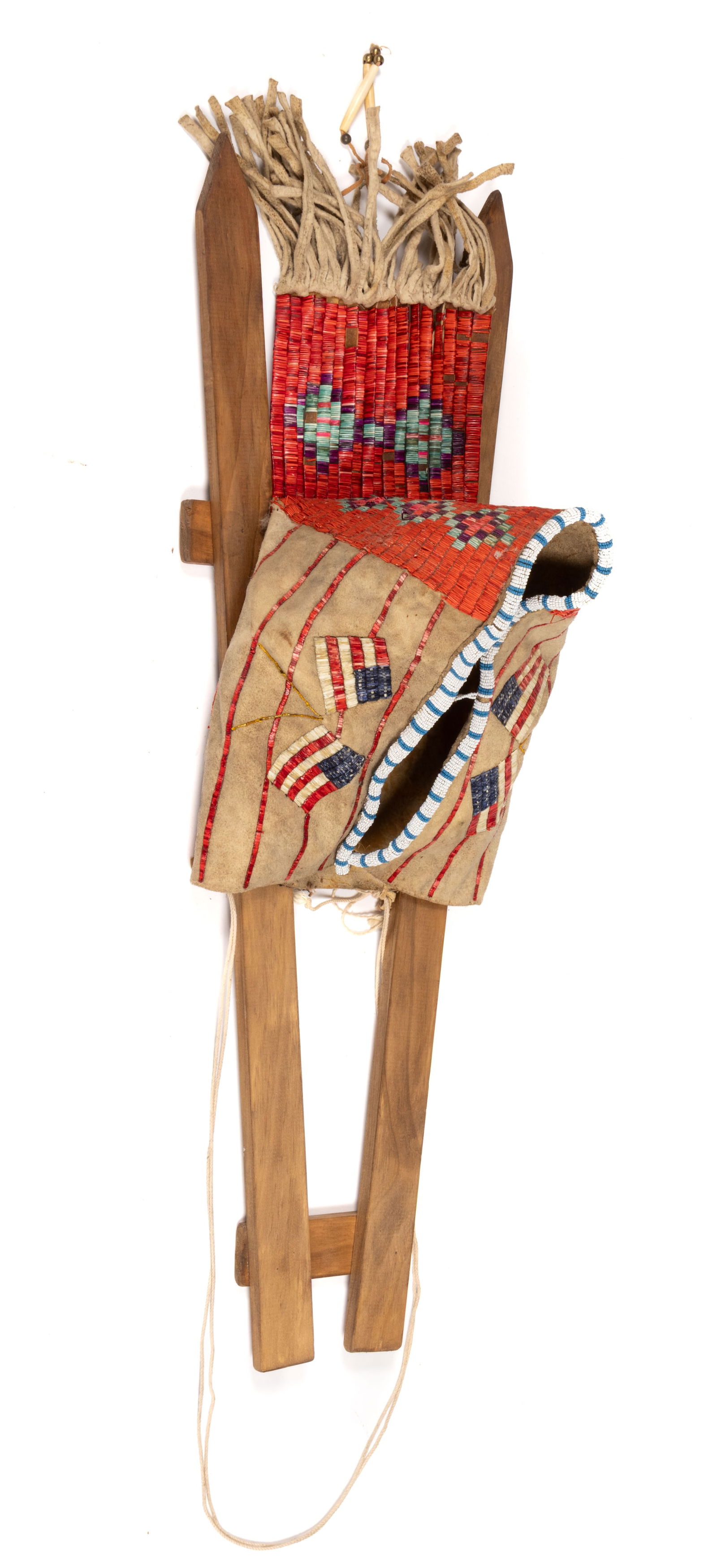 NATIVE AMERICAN PLAINS INDIAN U.S. FLAG PICTORIAL QUILLED AND BEADED HIDE CRADLEBOARD COVER / HOOD: NATIVE AMERICAN PLAINS INDIAN U.S. FLAG PICTORIAL QUILLED AND BEADED HIDE CRADLEBOARD COVER / HOOD, thread and sinew sewn, front edges with blue and white beading, sides with dyed quillwork featu