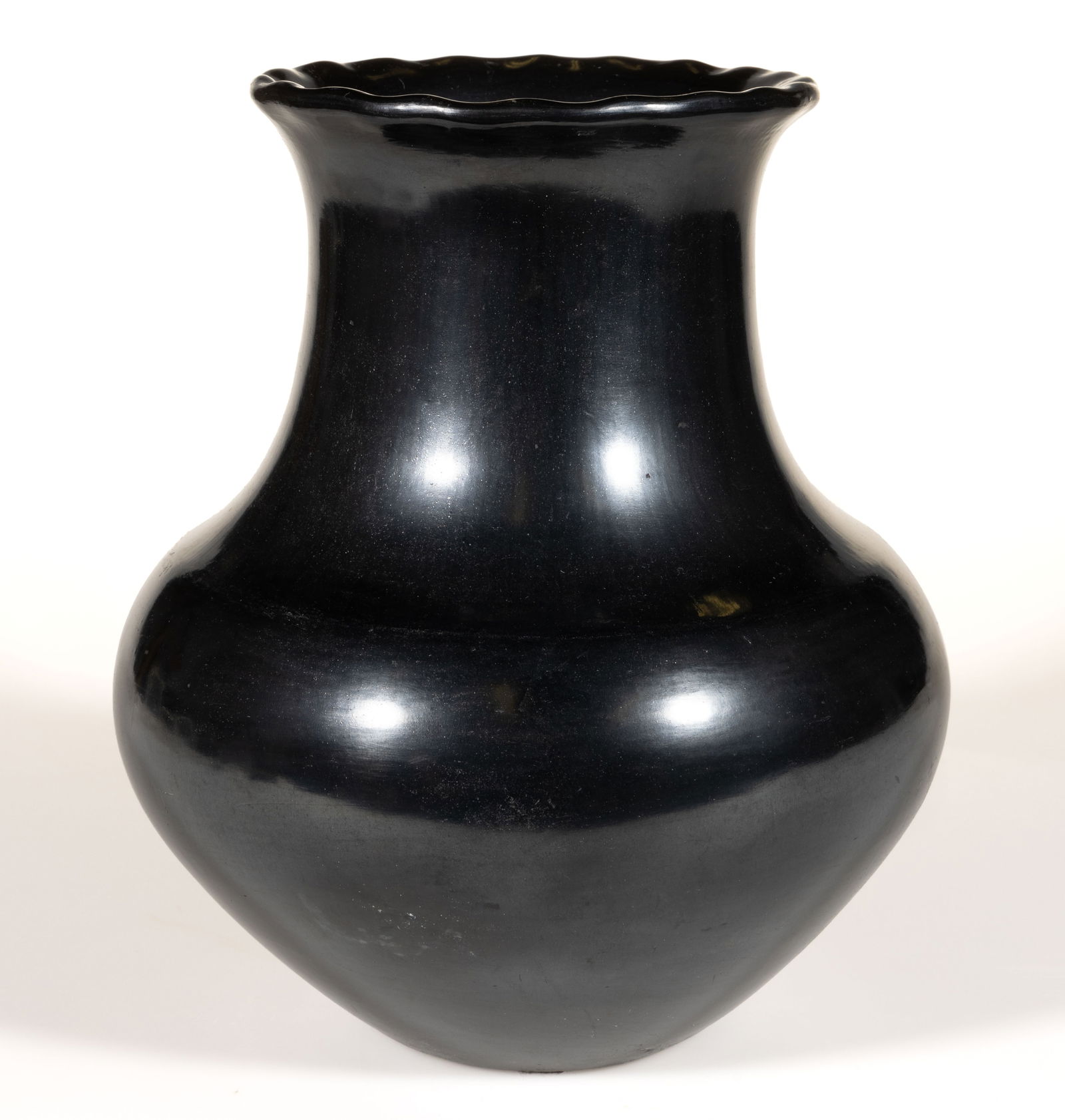 SIGNED MARIA POVEKA MARTINEZ (C.1886-1980) NATIVE AMERICAN SAN ILDEFONSO PUEBLO BLACKWARE POTTERY: SIGNED MARIA POVEKA MARTINEZ (C.1886-1980) NATIVE AMERICAN SAN ILDEFONSO PUEBLO BLACKWARE POTTERY JAR / OLLA, having squat lower body with elongated graceful neck, fluted rim, and