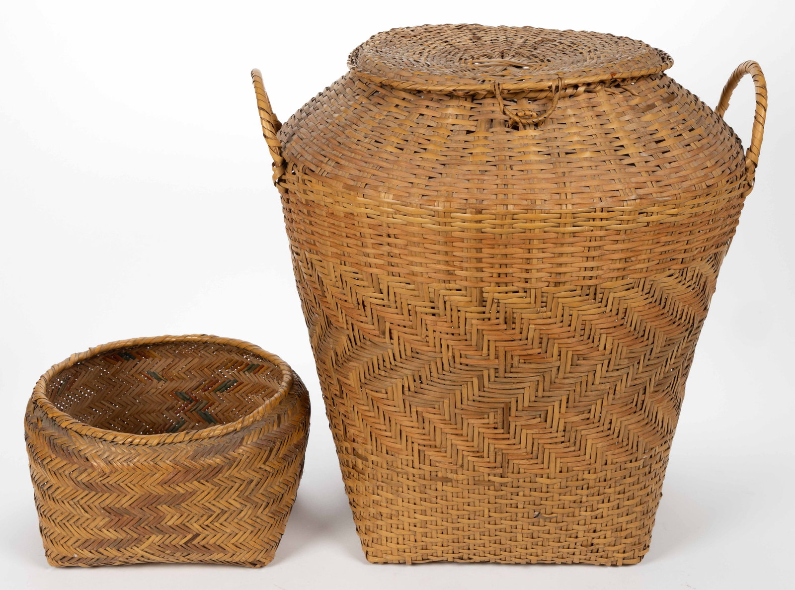 NATIVE AMERICAN CHOCTAW DECORATED WOVEN-SPLINT BASKETS, LOT OF TWO: NATIVE AMERICAN CHOCTAW DECORATED WOVEN-SPLINT BASKETS, LOT OF TWO, (updated 6/17/2025) each natural and dyed rivercane, single-weave, having a round rim and square base, comprising a large covered ba