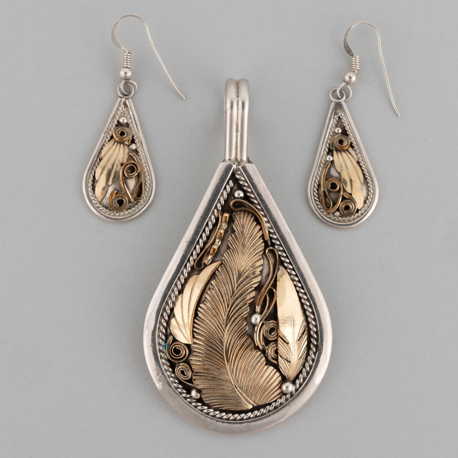 JUSTIN MORRIS (NAVAJO) NATIVE AMERICAN 12K GOLD-FILLED AND STERLING SILVER THREE-PIECE JEWELRY SET: JUSTIN MORRIS (NAVAJO) NATIVE AMERICAN 12K GOLD-FILLED AND STERLING SILVER THREE-PIECE JEWELRY SET, comprising a large pendant and a pair of drop earrings, each piece being teardrop form, featuring go