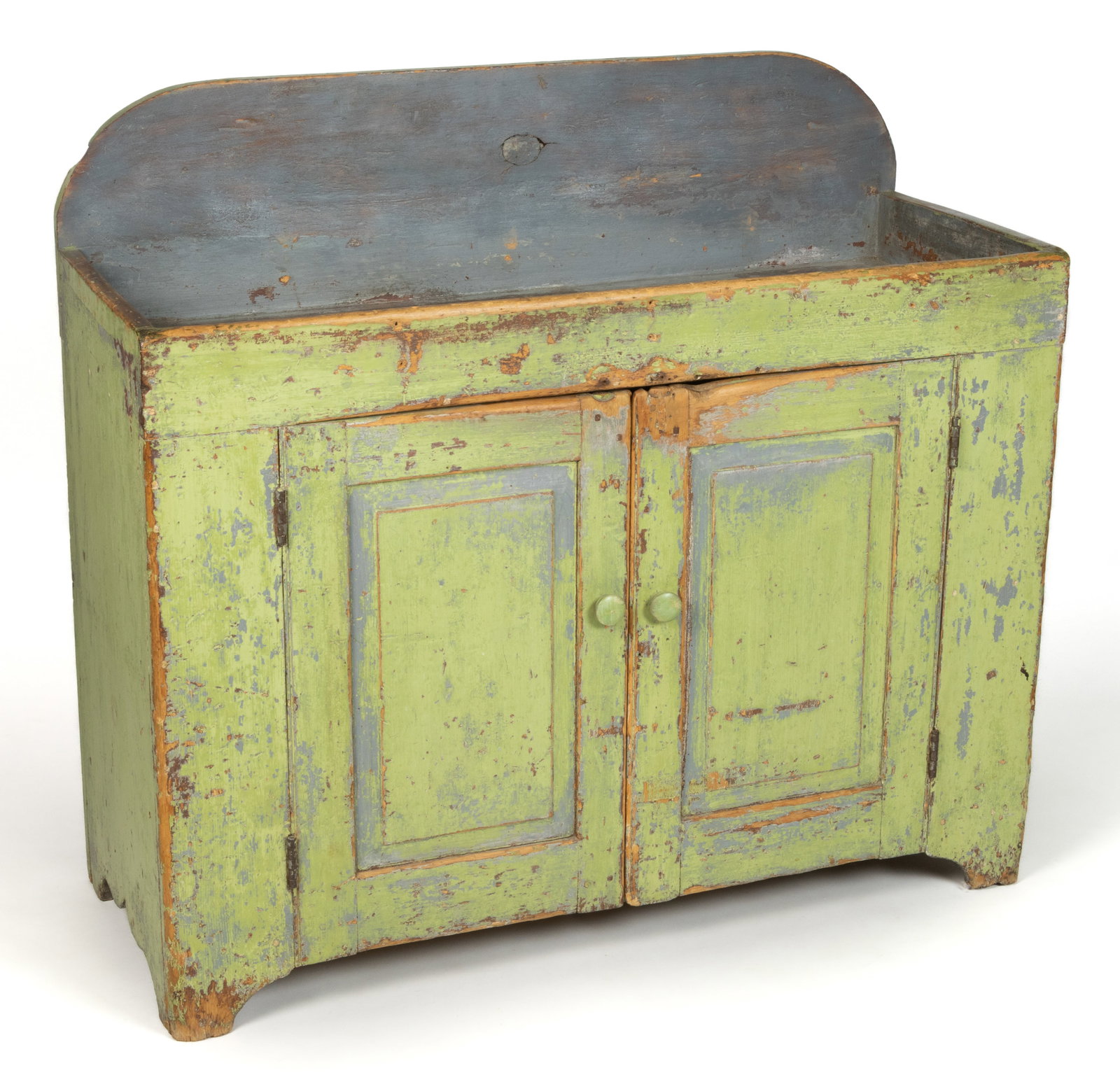 PENNSYLVANIA PAINTED PINE DRY SINK: PENNSYLVANIA PAINTED PINE DRY SINK, the high arched backsplash over a shallow well, and two hinged raised-panel cabinet doors which conceal a single fixed shelf, the whole flanked by solid ends and ra