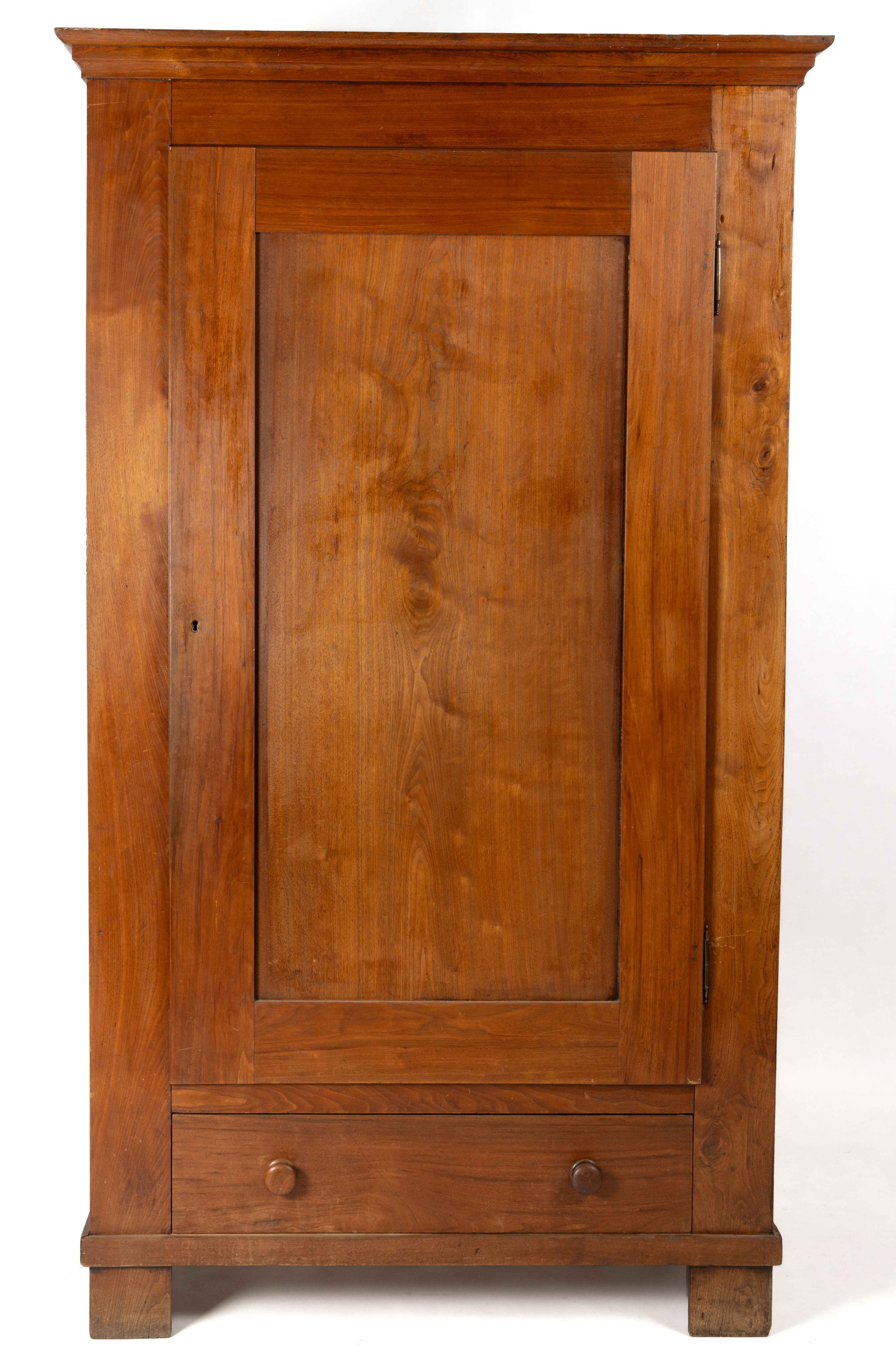 AMERICAN, POSSIBLY CENTRAL MISSOURI, LATE FEDERAL WALNUT WARDROBE / CLOTHES PRESS: AMERICAN, POSSIBLY CENTRAL MISSOURI, LATE FEDERAL WALNUT WARDROBE / CLOTHES PRESS, the overhanging molded cornice over a large single fielded-panel hinged cabinet door hung on brass French-style hinge