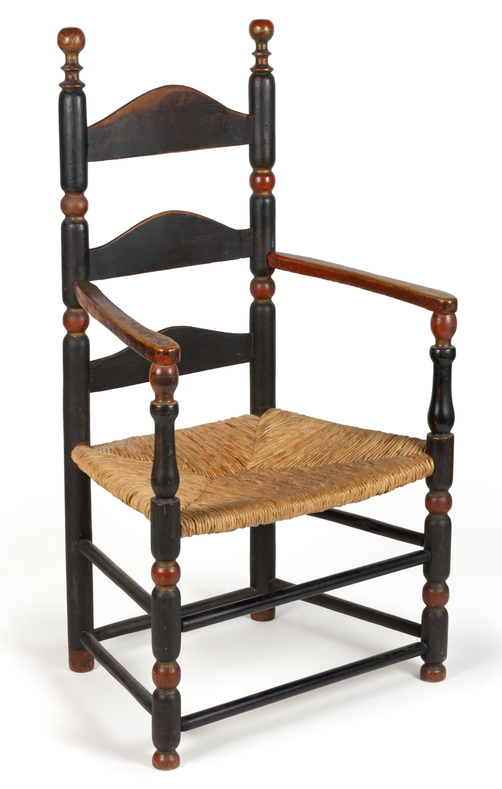 AMERICAN PAINTED LADDERBACK RUSH-SEAT ARMCHAIR: AMERICAN PAINTED LADDERBACK RUSH-SEAT ARMCHAIR, three-slat form with turned finials and posts, shaped arms, and double box stretcher, retaining an old polychrome surface. Late 18th/early 19th century.