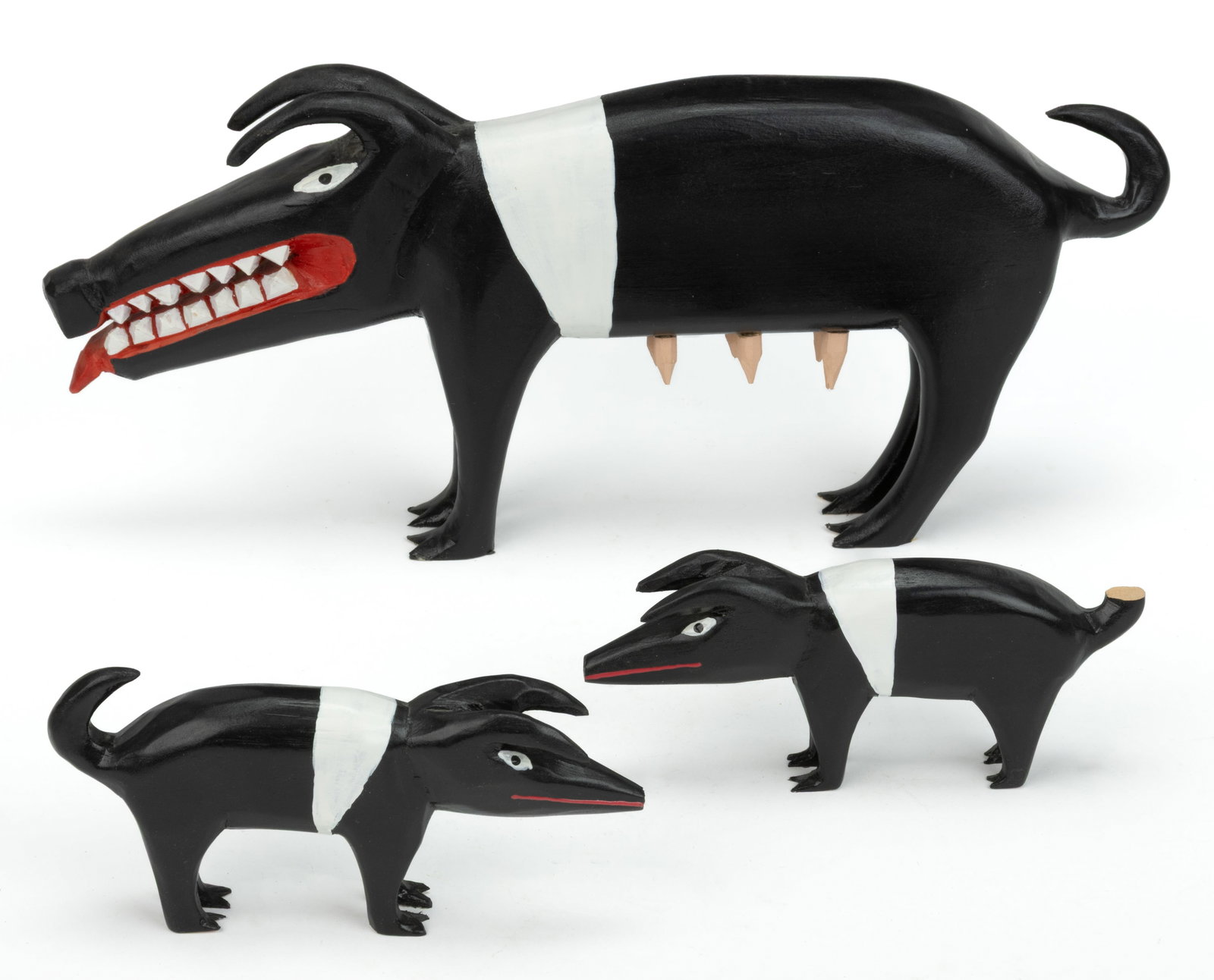 MINNIE ADKINS (KENTUCKY, B. 1934) OUTSIDER ART CARVED AND PAINTED MOTHER PIG AND PIGLETS, LOT OF: MINNIE ADKINS (KENTUCKY, B. 1934) OUTSIDER ART CARVED AND PAINTED MOTHER PIG AND PIGLETS, LOT OF THREE, each of similar form, the mother bearing her teeth and sticking out her tongue, the babies each