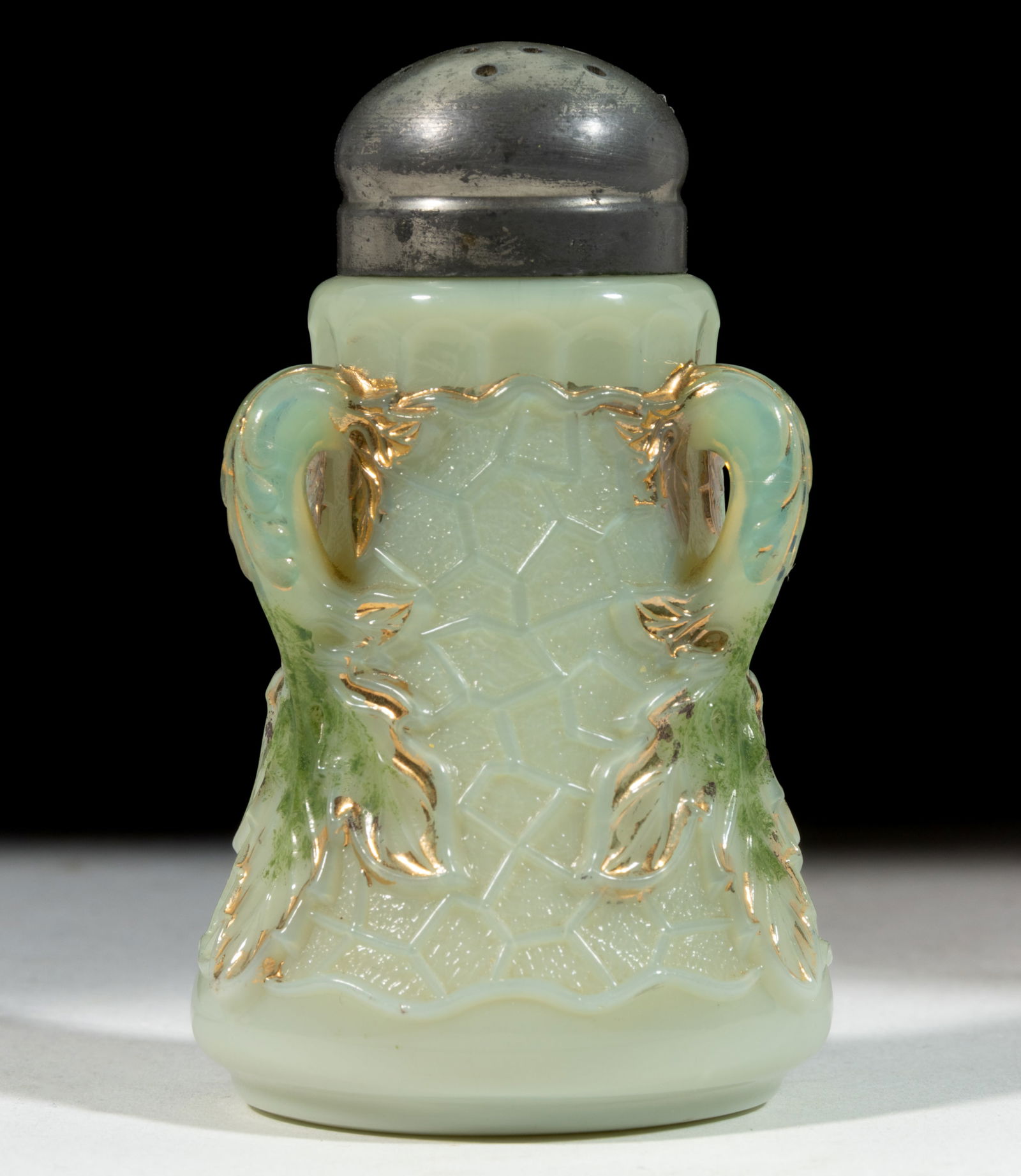 NORTHWOOD MAPLE LEAF SALT SHAKER: NORTHWOOD MAPLE LEAF SALT SHAKER, custard with green stain and gilt decoration, having a period lid. Northwood Glass Co. Early 20th century. 3 3/8" H.Literature: Lechner - The World of Salt Shakers, V