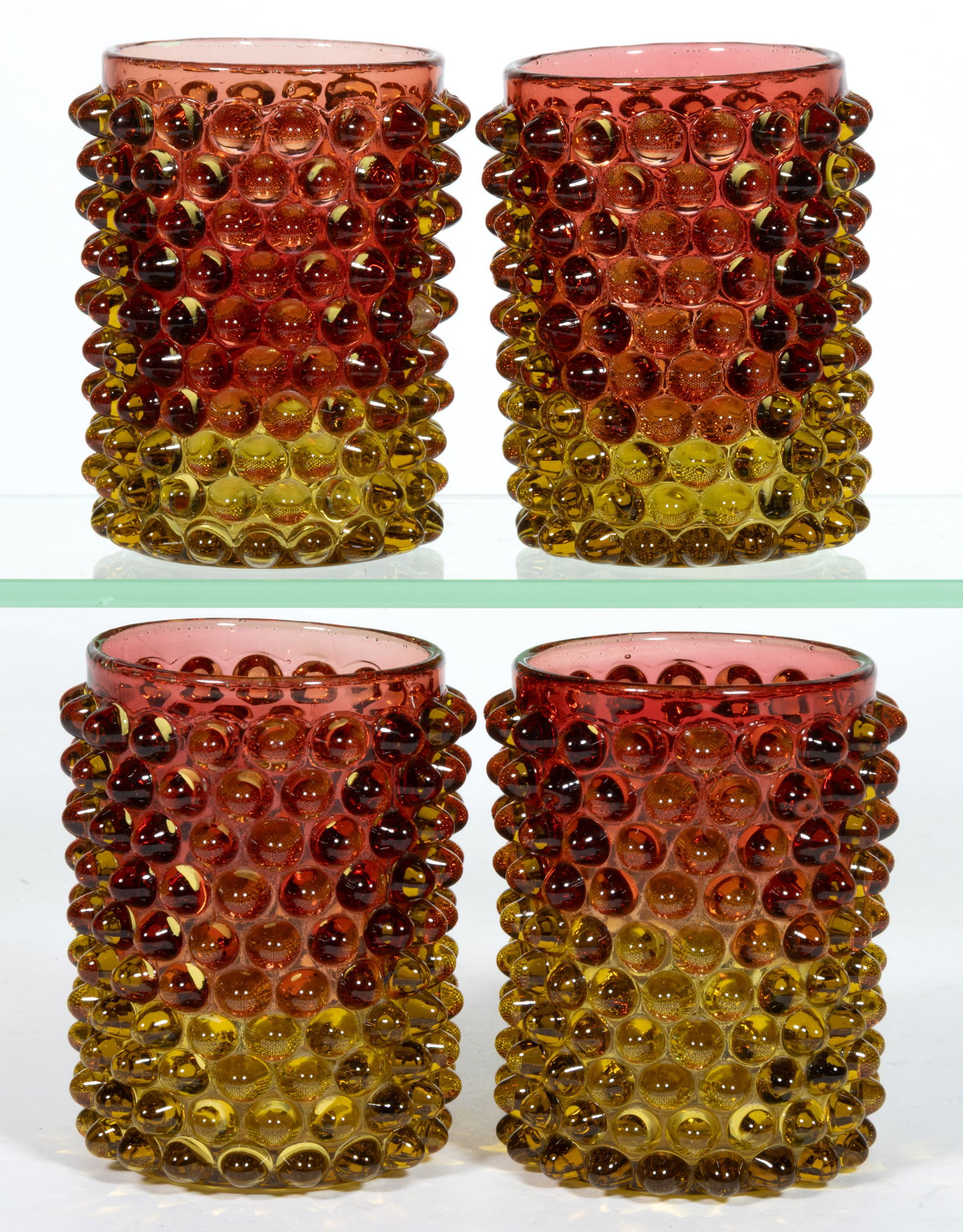 HOBBS NO. 323 / DEWDROP TUMBLERS, SET OF FOUR: HOBBS NO. 323 / DEWDROP TUMBLERS, SET OF FOUR, ruby amber/Amberina, each with polished pontil mark. Hobbs, Brockunier & Co. Fourth quarter 19th century. 3 3/4" H. Provenance: