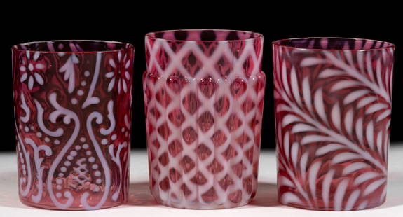 ASSORTED BLOWN OPALESCENT GLASS TUMBLERS, LOT OF THREE: ASSORTED BLOWN OPALESCENT GLASS TUMBLERS, LOT OF THREE, comprising a Fern, a Ribbed Lattice, and an Arabian Nights all in cranberry opalescent, each having a fire-polished rim. Various makers. Late 19