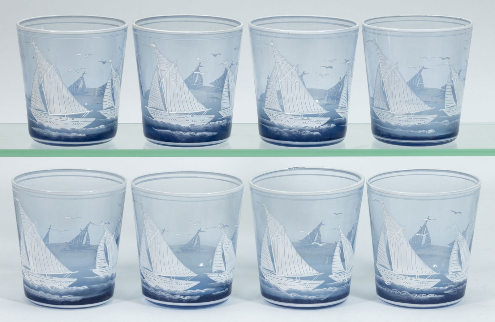 VINTAGE SAILBOAT ENAMEL-DECORATED TUMBLERS, SET OF EIGHT: VINTAGE SAILBOAT ENAMEL-DECORATED TUMBLERS, SET OF EIGHT, light blue, slightly tapered form, each depicting five racing boats with seagulls in flight above, one boat inscribed "ER / 32" on sail and an