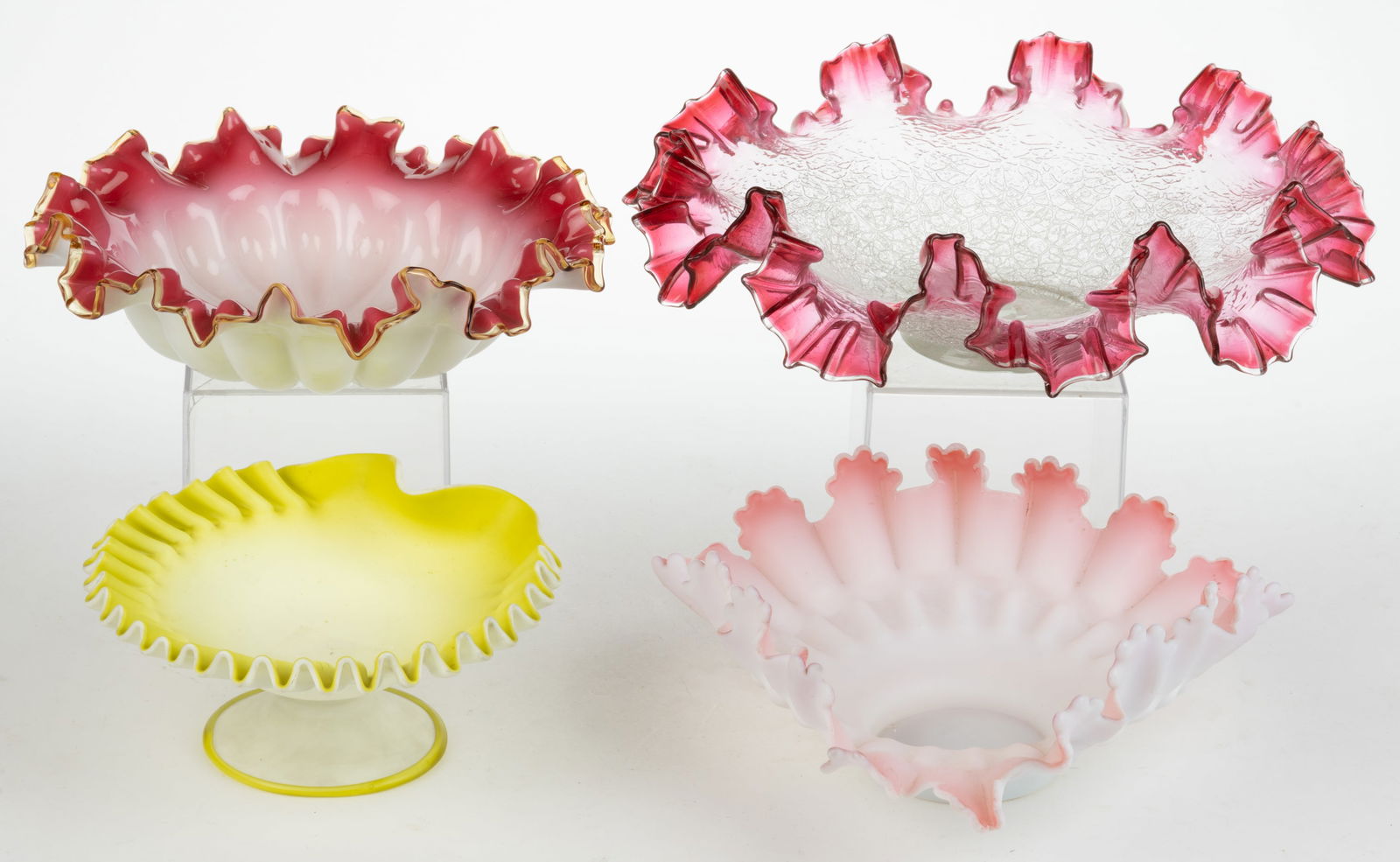 ASSORTED VICTORIAN ART GLASS BOWLS / BRIDE'S BASKETS, LOT OF FOUR: ASSORTED VICTORIAN ART GLASS BOWLS / BRIDE'S BASKETS, LOT OF FOUR, each ruffled-rim, comprising a cranberry to colorless craquelle, a rose cased opal example (reacts under black light) with amber trim
