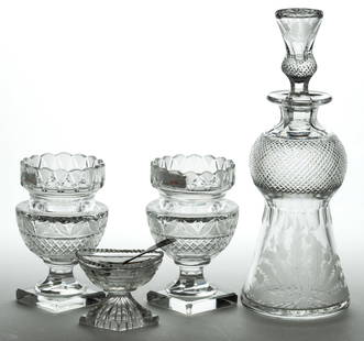 ASSORTED BRITISH CUT GLASS ARTICLES, LOT OF FOUR PLUS SPOON: ASSORTED BRITISH CUT GLASS ARTICLES, LOT OF FOUR PLUS SPOON, colorless, comprising a signed Edinburgh Crystal thistle-form decanter with engraved thistles and original stopper, a pair of small urns, a