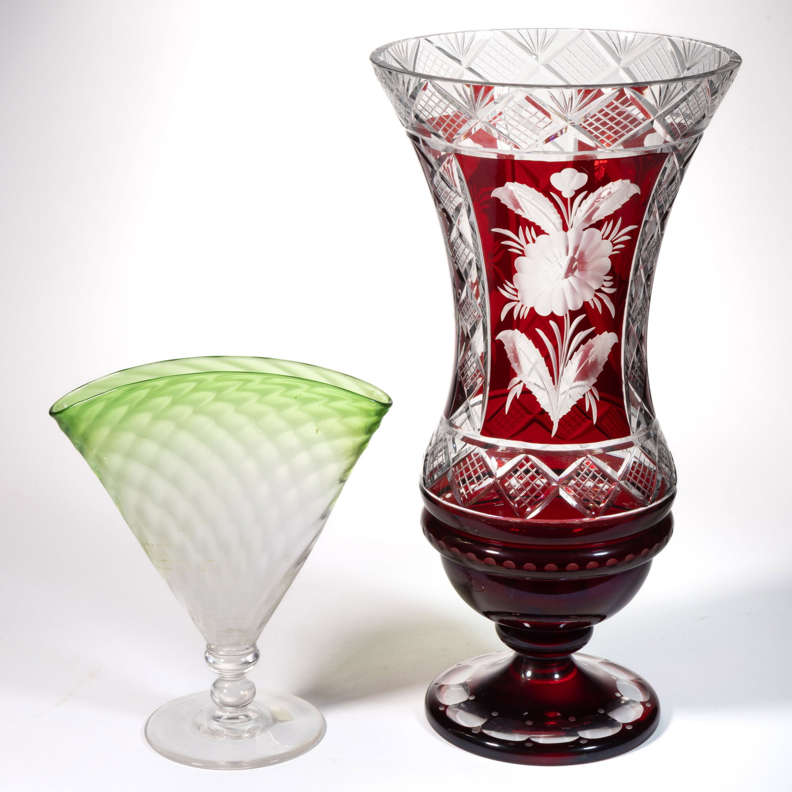 ASSORTED GLASS VASES, LOT OF TWO: ASSORTED GLASS VASES, LOT OF TWO, comprising a shaded Steuben Pomona Green form No. 6287 fan vase, and a Bohemian ruby-stained colorless cut and engraved vase with reserves featuring floral engraving.