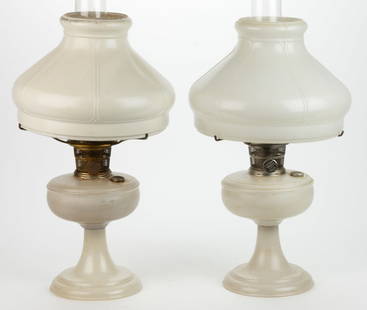 ALADDIN MODEL NO. 100 / VENETIAN KEROSENE STAND LAMPS, LOT OF TWO: ALADDIN MODEL NO. 100 / VENETIAN KEROSENE STAND LAMPS, LOT OF TWO, Satin White Alpha Crystal, unpatterned fonts with a circular-form foot, underside of foot with three oblong feet, glass threaded conn