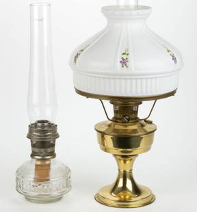 ALADDIN CONTEMPORARY KEROSENE STAND LAMPS, LOT OF TWO: ALADDIN CONTEMPORARY KEROSENE STAND LAMPS, LOT OF TWO, comprising a colorless glass Genie lamp, and a brass Hong Kong Model 23 fitted with a milk glass shade having hand-painted floral decoration, eac