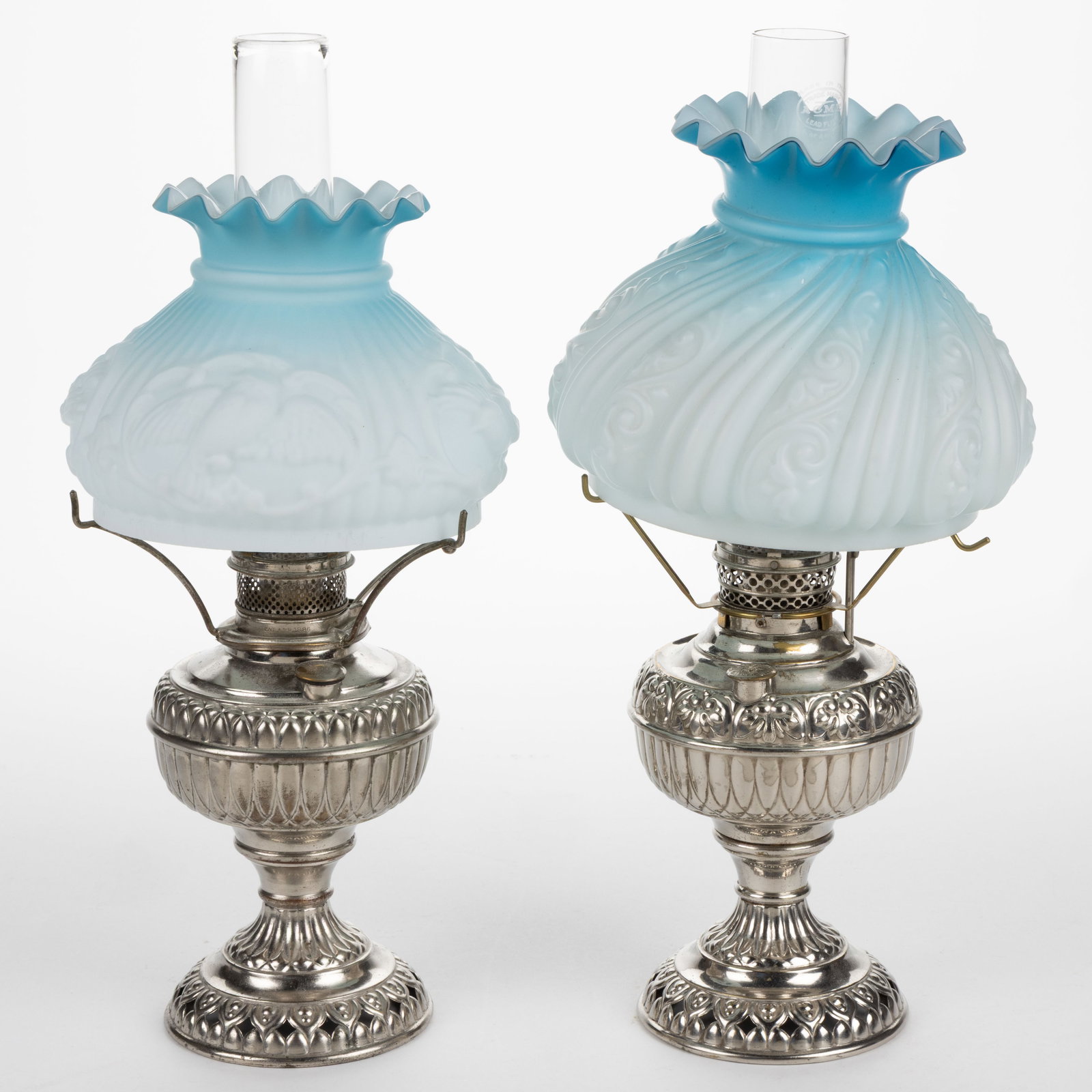 ASSORTED MANUFACTURER'S KEROSENE CENTRAL-DRAFT STAND LAMPS, LOT OF TWO: ASSORTED MANUFACTURER'S KEROSENE CENTRAL-DRAFT STAND LAMPS, LOT OF TWO, nickel-plated brass and metal, globular-form fonts with paneled ribbing, comprising of a Jr. Rochester and an E. Miller's Tiny J