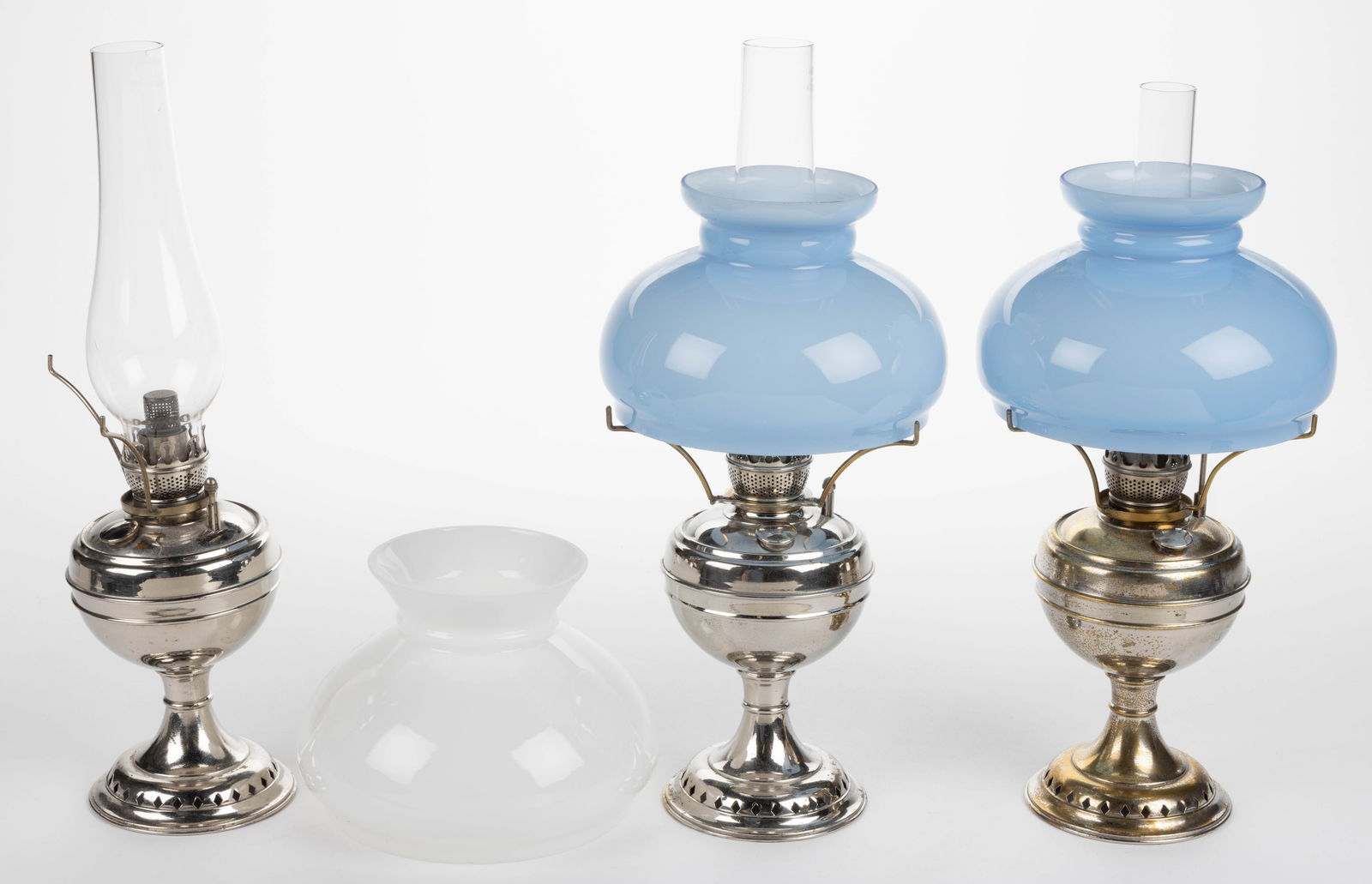 ANSONIA BRASS & COPPER CO. "LITTLE JEWEL" KEROSENE CENTRAL-DRAFT STAND LAMPS, LOT OF THREE: ANSONIA BRASS & COPPER CO. "LITTLE JEWEL" KEROSENE CENTRAL-DRAFT STAND LAMPS, LOT OF THREE, nickel-plated brass and metal, globular-form unpatterned fonts, each shoulder with a drip catcher, impressed